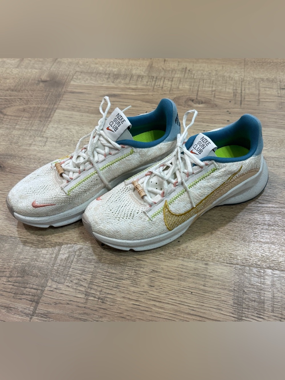 Nike Kids White Sneakers with Gold Swoosh and Teal Lining